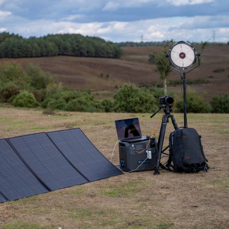 Bluetti AC200MAX Power Station charging multiple devices outdoors during an activity