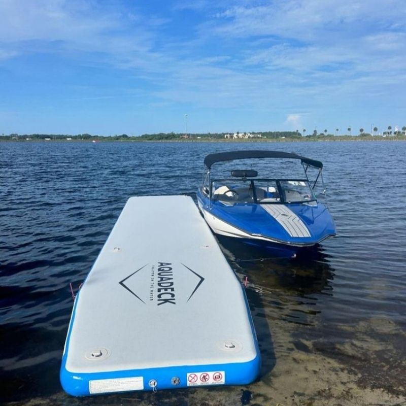 Aquadeck Inflatable Straight Pontoon moored to a dock in calm waters