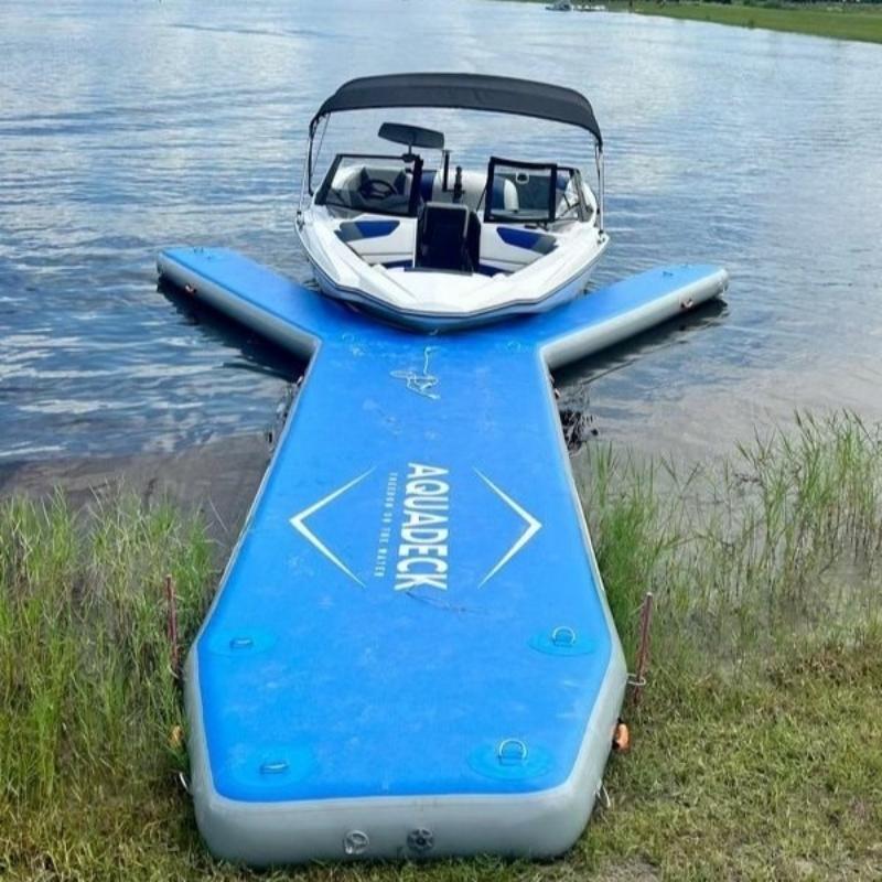 Aquadeck inflatable Y pontoon with blue floating dock and boat