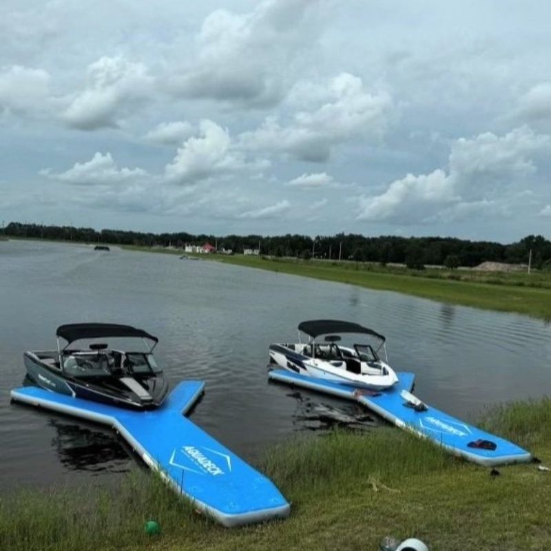 Two boats docked on Aquadeck inflatable Y pontoons in water