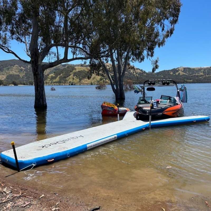 Aquadeck Inflatable Y Pontoon moored by a lake with a boat