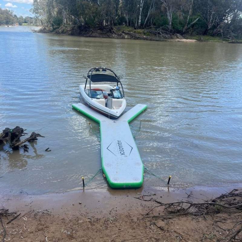 Aquadeck inflatable Y pontoon setup on a lake with a docked boat