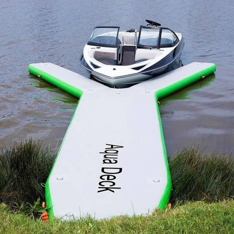 Aquadeck inflatable Y pontoon next to Ski Nautique boat on a lake