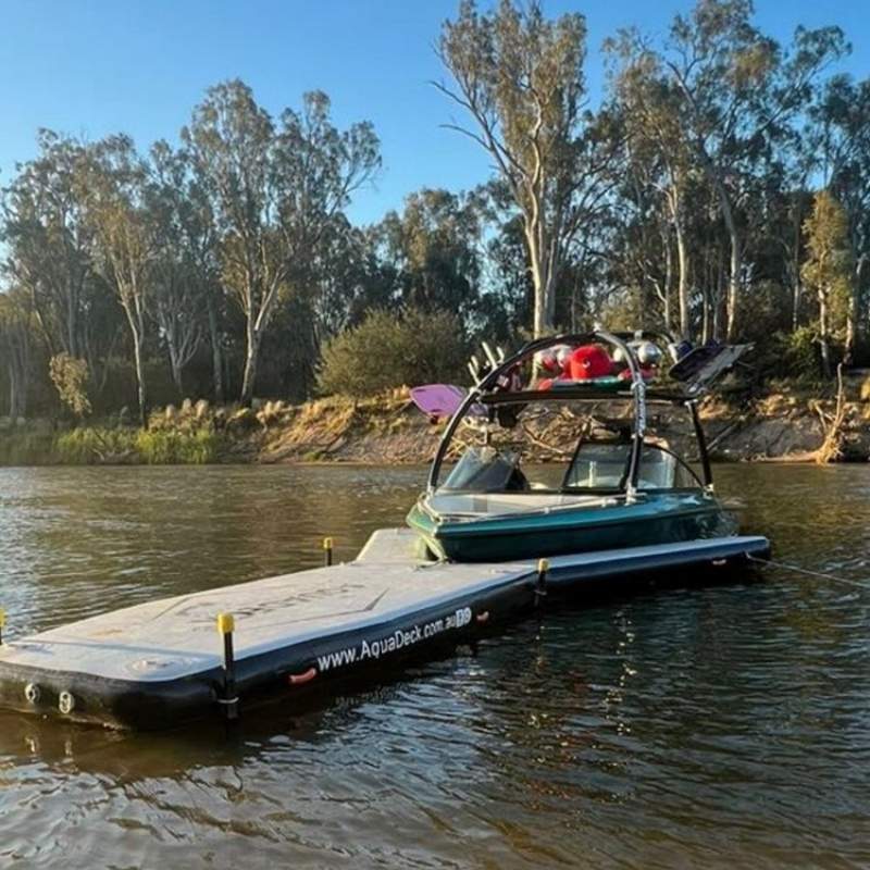 Aquadeck Inflatable Y Pontoon during sunset with a boat