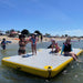 Family enjoying Bartlett 4m X 2m deck extender inflatable pontoon at the beach