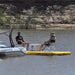 Two people sitting on Bartlett 4m X 2m deck extender inflatable pontoon with a cooler on a lake