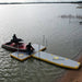 Speedboat docking next to Bartlett 4m X 2m V Deck inflatable pontoon on a quiet lake