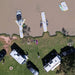 Aerial view of campers with Bartlett 8m X 5m Y-shaped inflatable pontoon by the lake