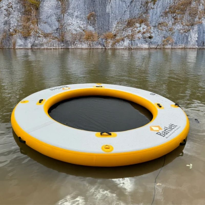 Bartlett Circle Deck Water Hammock floating on a calm river near scenic cliffs