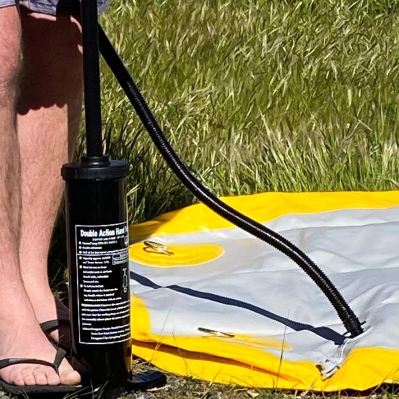 Close-up view of Bartlett Circle Deck Water Hammock being inflated with a hand pump