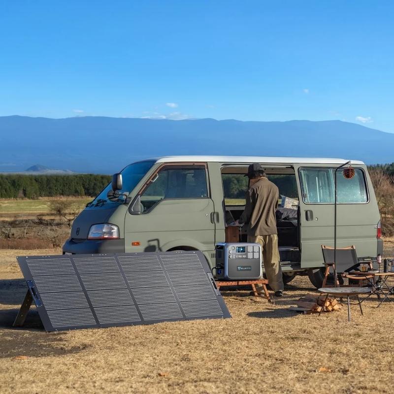 Bluetti PV350D solar panel setup next to a van during a camping trip, showcasing its outdoor use