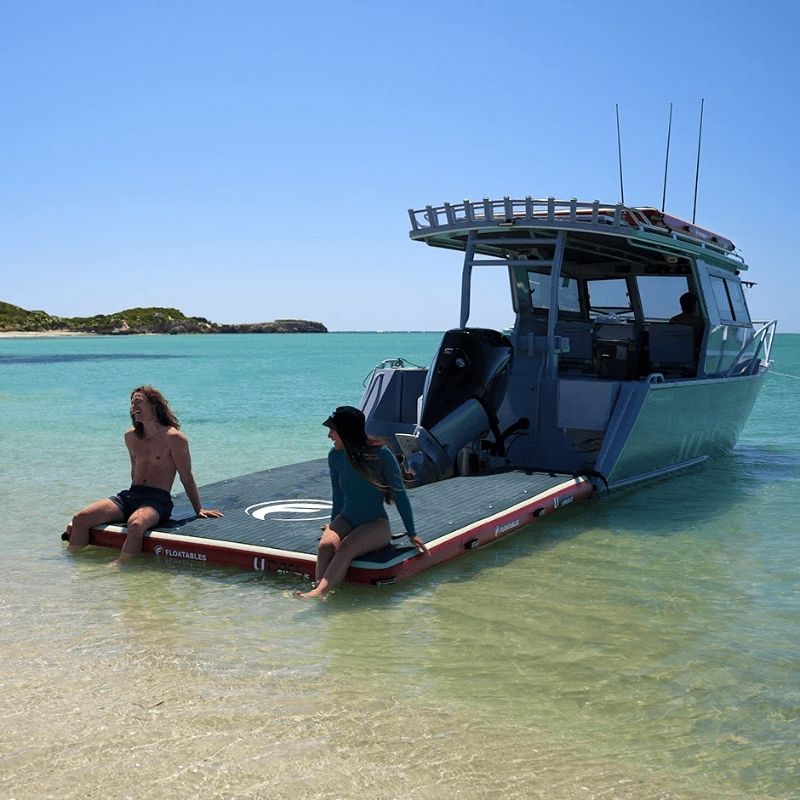 Floatables U-Dock inflatable boat dock attached to speedboat near shallow water