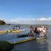 Group standing on Bartlett Straight Inflatable Pontoon at a lake