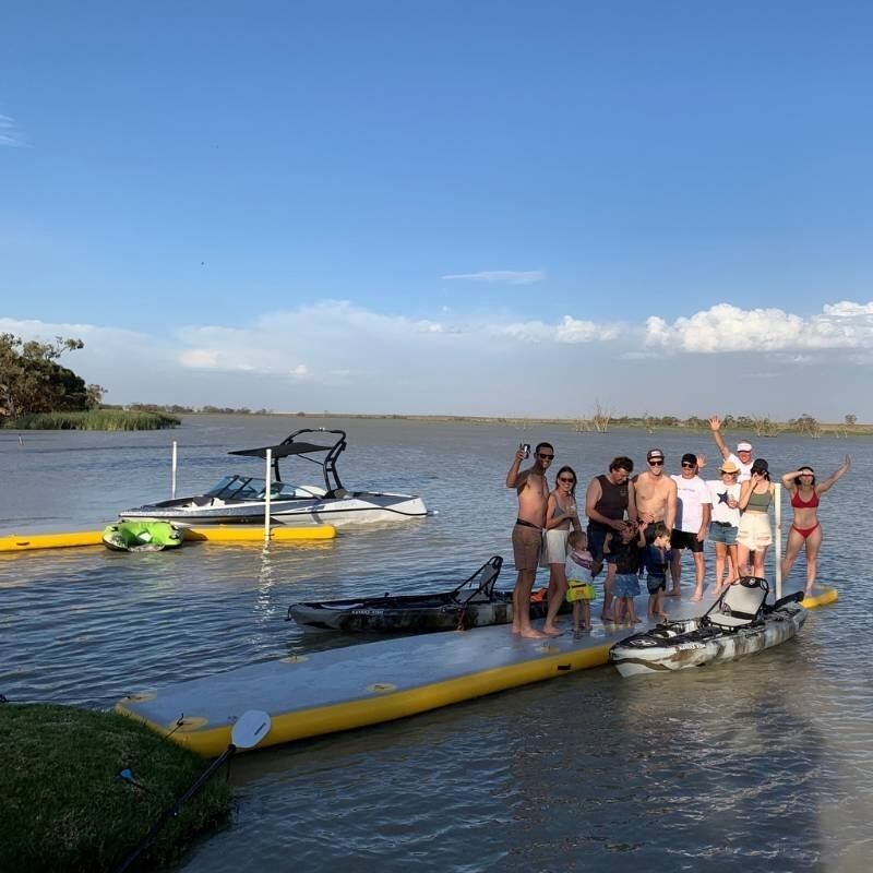 Group standing on Bartlett Straight Inflatable Pontoon at a lake