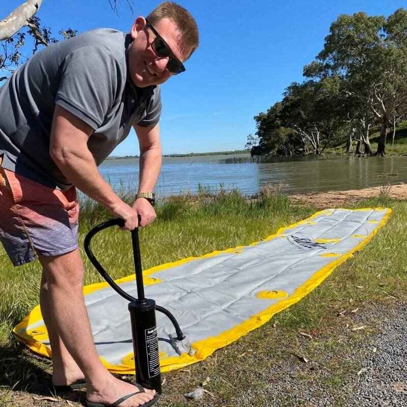 Man inflating Bartlett Straight Inflatable Pontoon with hand pump