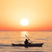 Oru Beach LT kayak paddling at sunset on a calm ocean