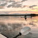 Oru Coast Xt kayak paddling at sunset on a scenic calm lake