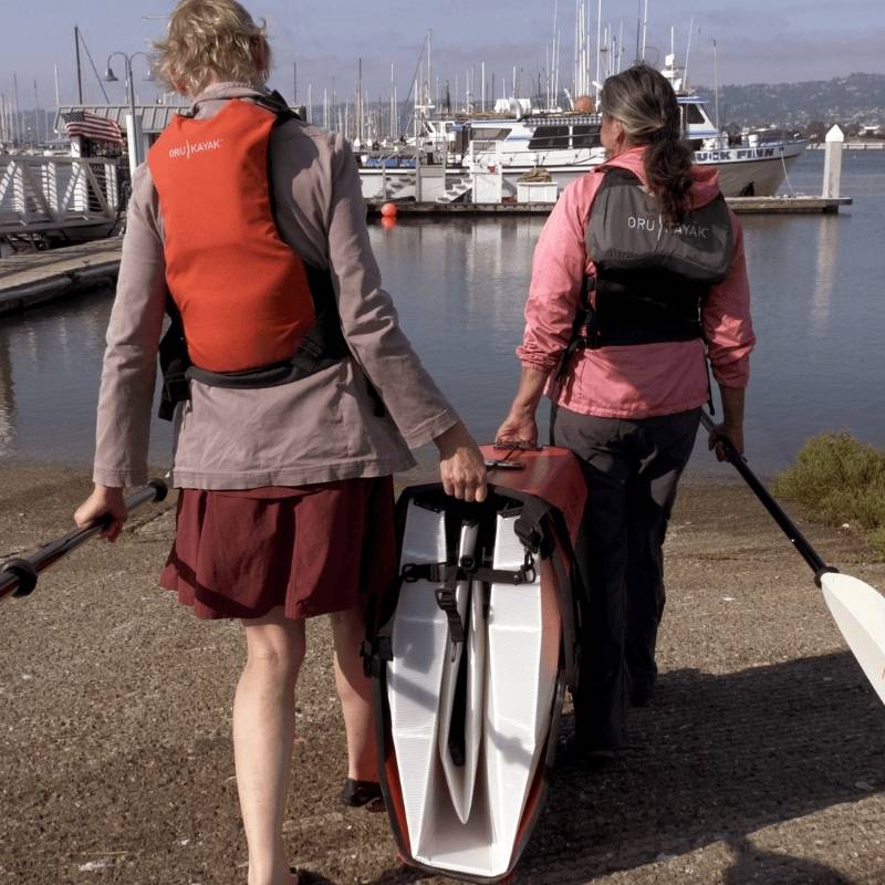 Oru Kayak Haven TT packed and carried to the water by two people