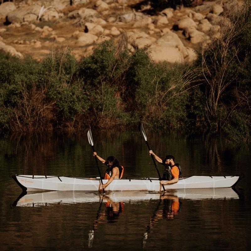 Oru Kayak Haven TT tandem kayak paddling in calm river waters