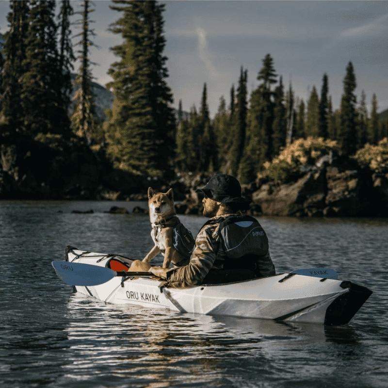 Oru Kayak Inlet on a lake with a dog onboard enjoying the water