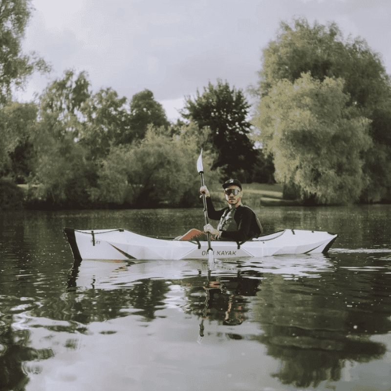 Oru Kayak Inlet on a lake with a dog onboard enjoying the water