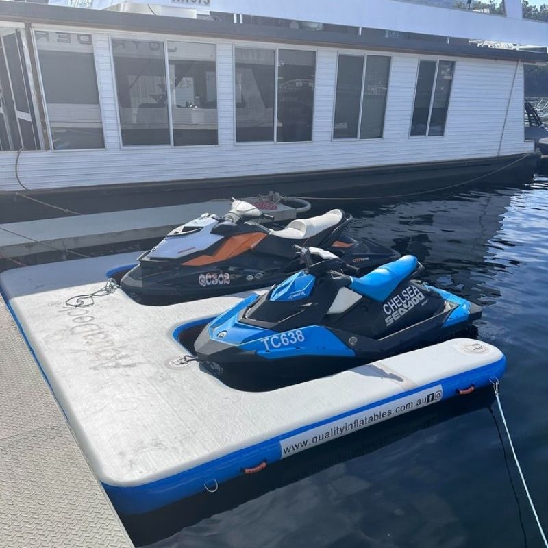 Portable Aquadeck dual jetski dock near a marina with houseboats