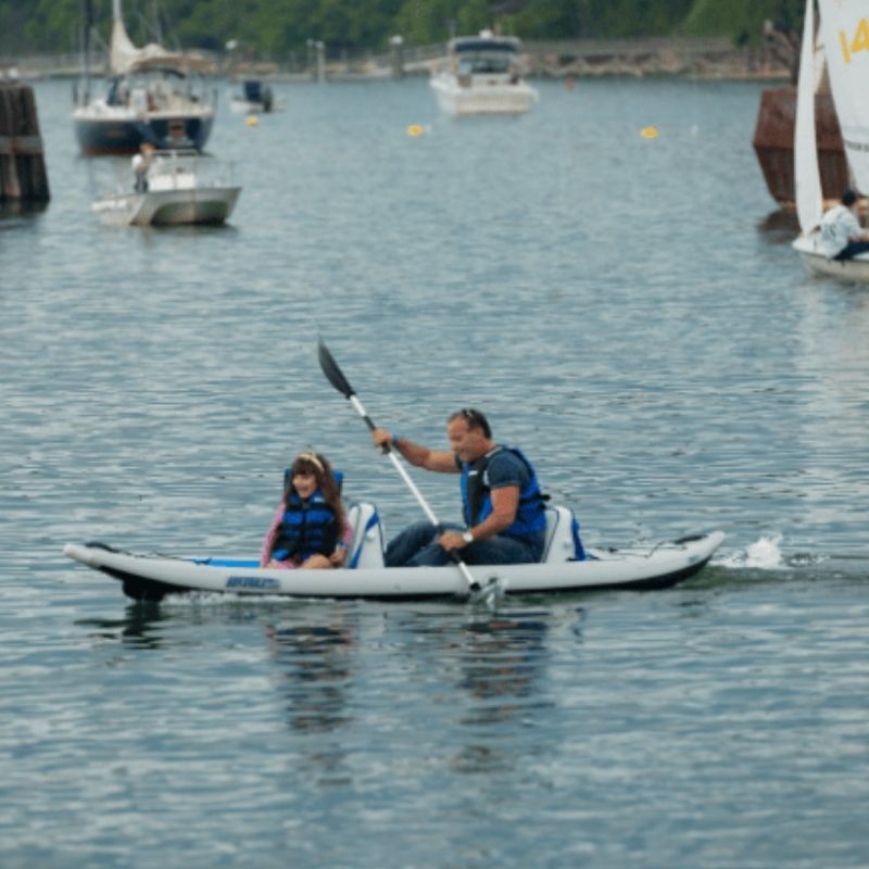 Father and child paddling Sea Eagle 385ft FastTrack inflatable kayak on water