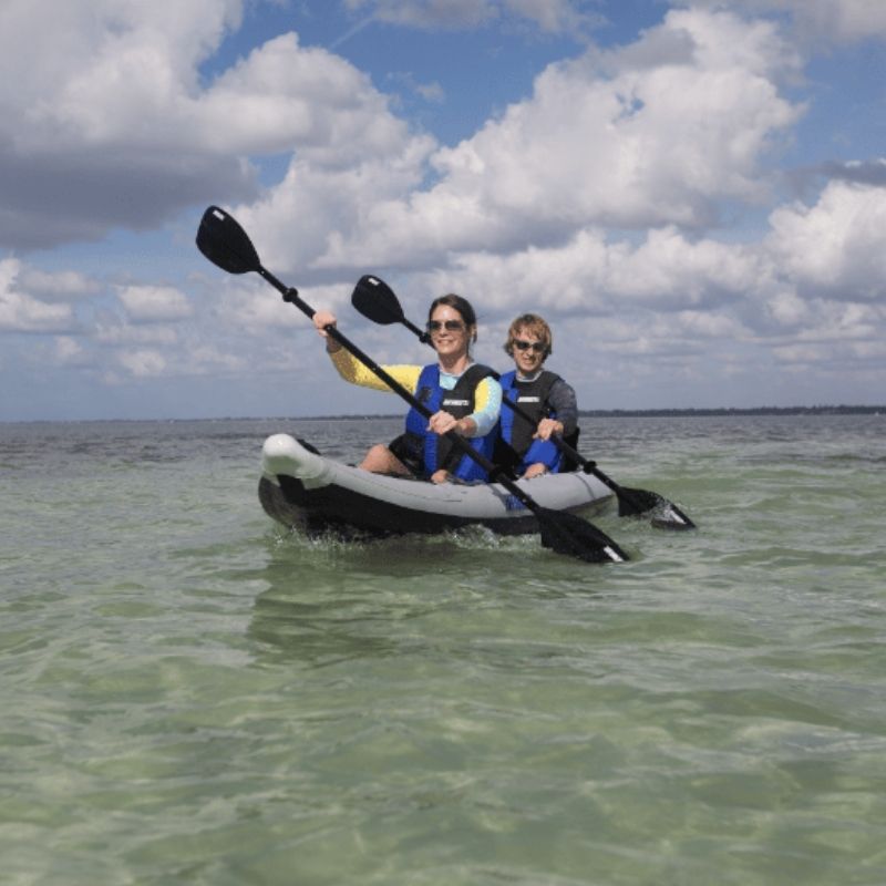 Two paddlers kayaking in a Sea Eagle 385ft FastTrack on shallow water