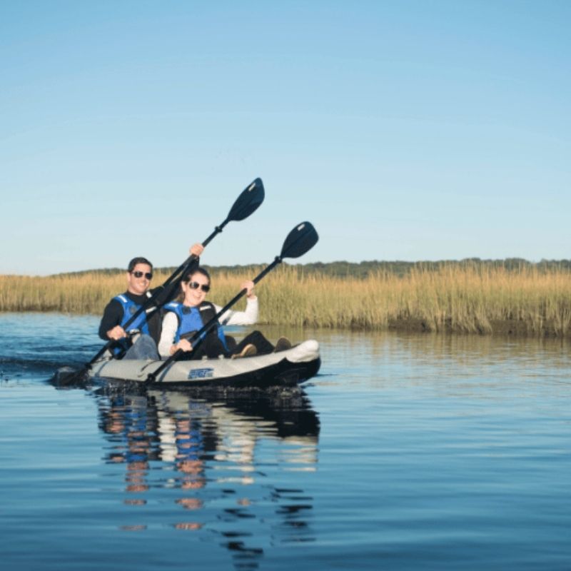 Sea Eagle 385ft FastTrack kayak paddling on a calm lake with two kayakers