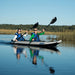 Two women kayaking on a calm lake in Sea Eagle 385ft FastTrack