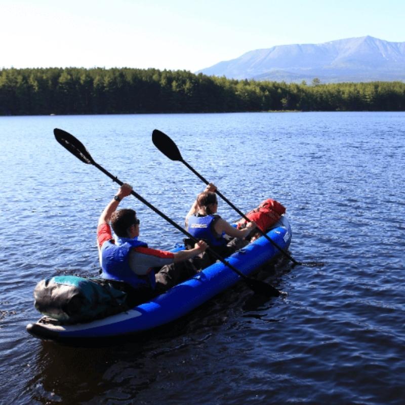 Sea Eagle 420x inflatable kayak on a lake with three paddlers