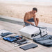 Man assembling the Terravent K1 Folding Kayak on the beach, preparing for kayaking