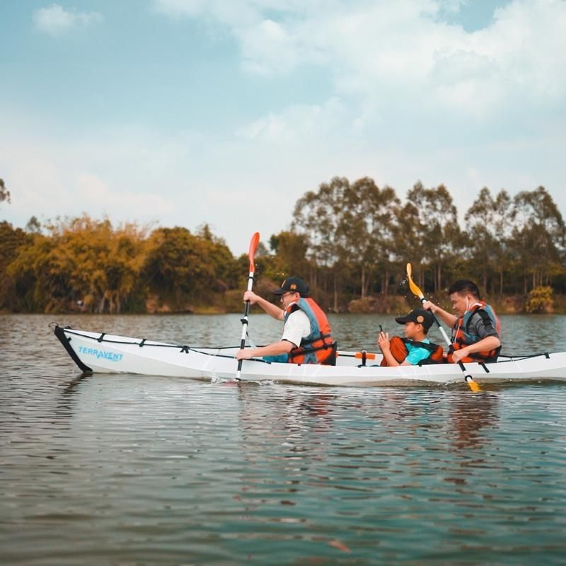 Two kayakers in a Terravent K3 Folding Kayak paddling on a peaceful evening lake